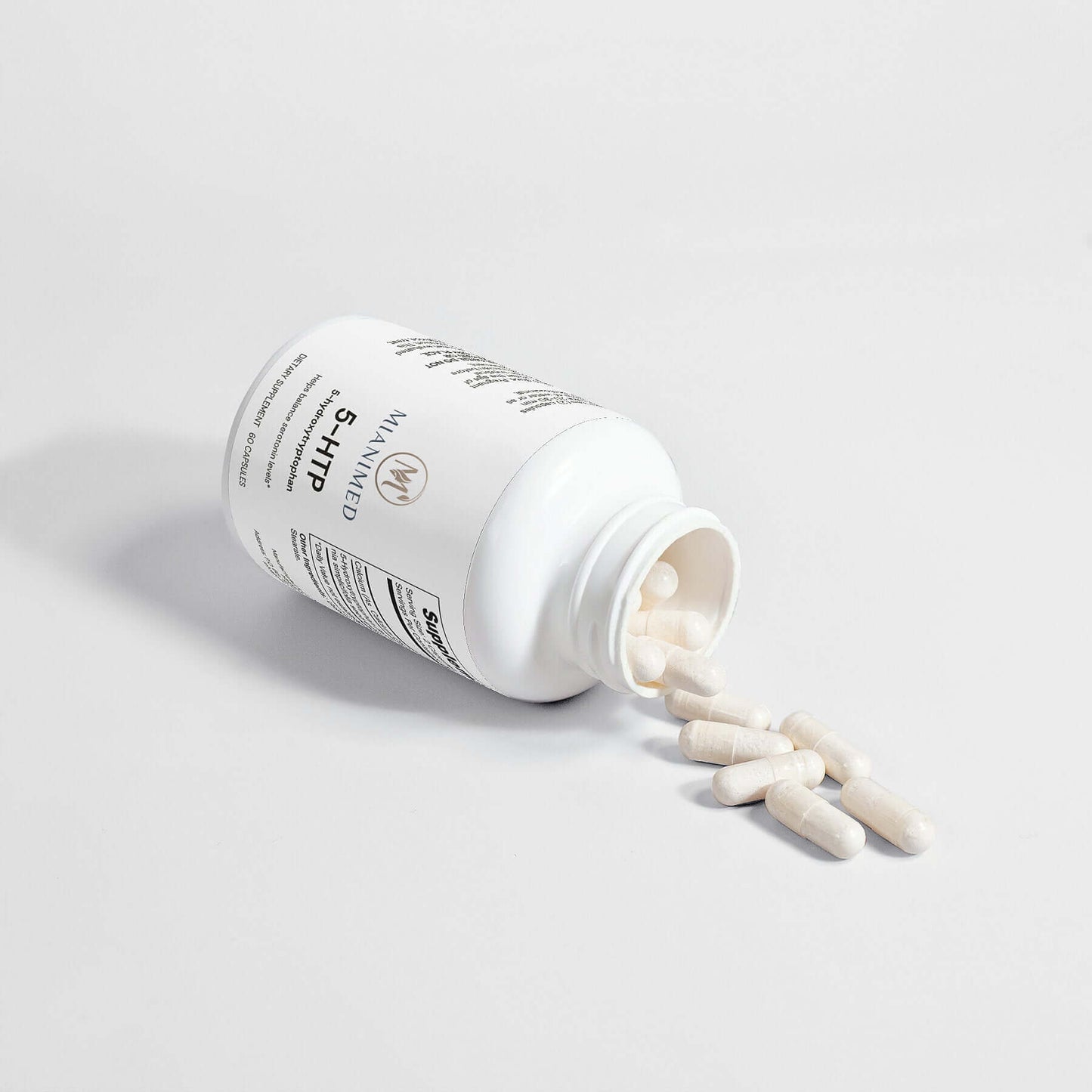 MIANIMED Premium skincare supplement bottle with capsules spilled.