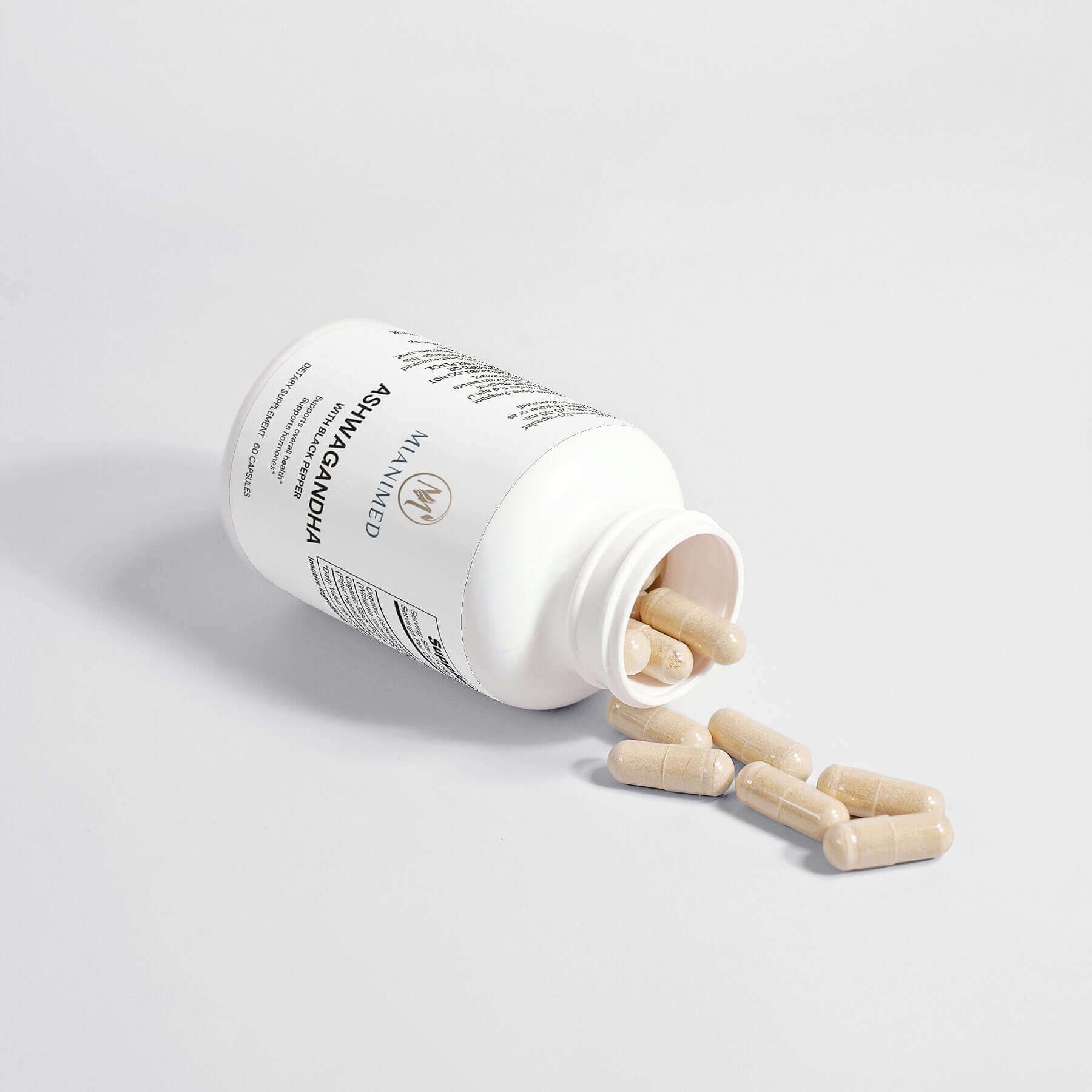 MIANIMED Premium skincare supplement bottle with capsules spilled out