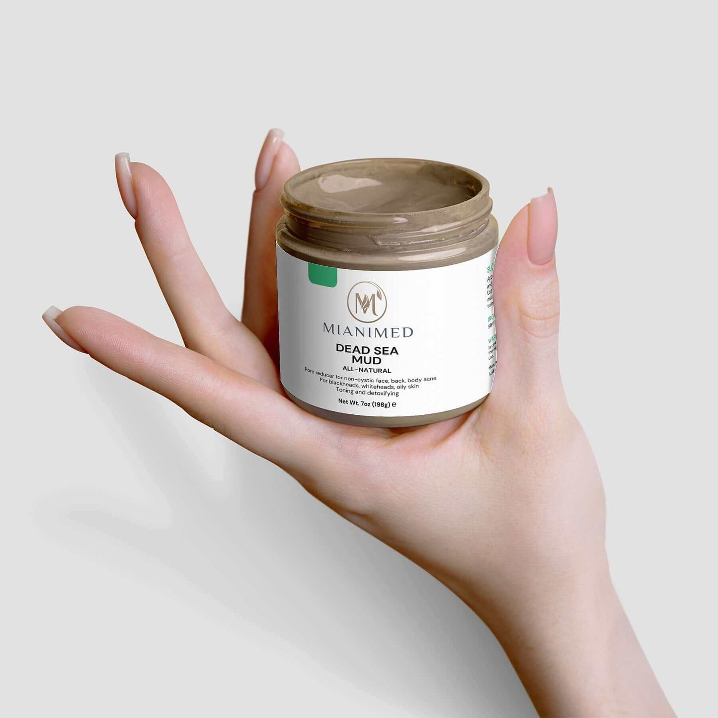 MIANIMED Premium Skincare Dead Sea Mud held in hand.