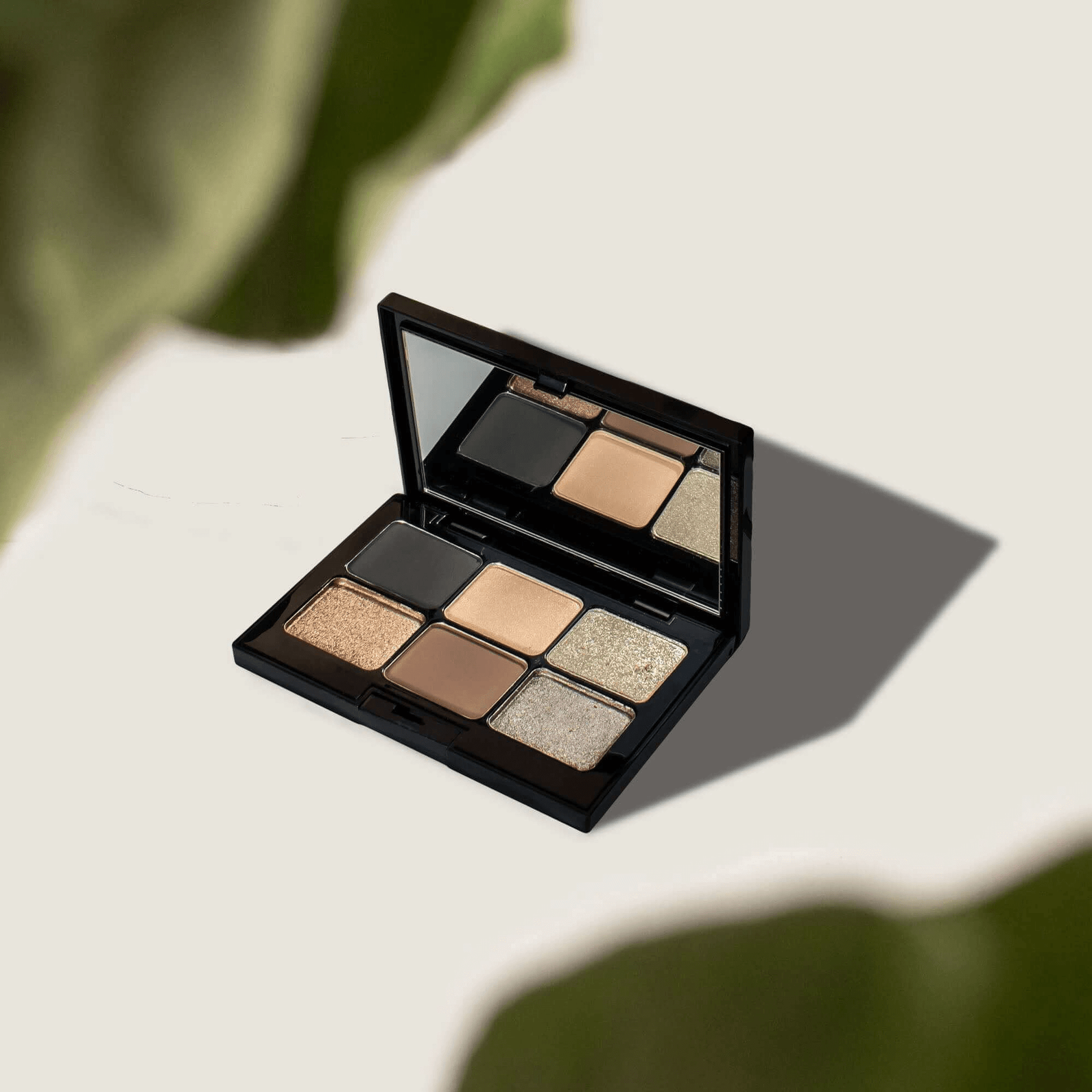 MIANIMED premium skincare eyeshadow palette with six earthy tones shades, open with a mirror on an elegant background.