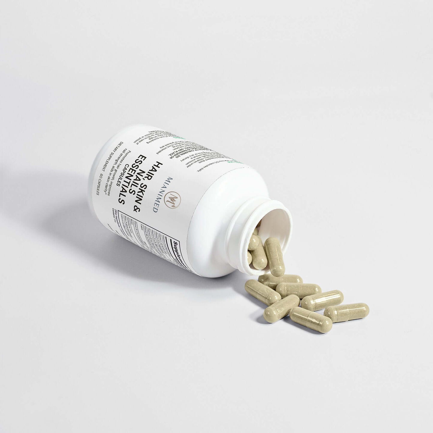 MIANIMED premium skincare capsules spilling from a white bottle on a white background.