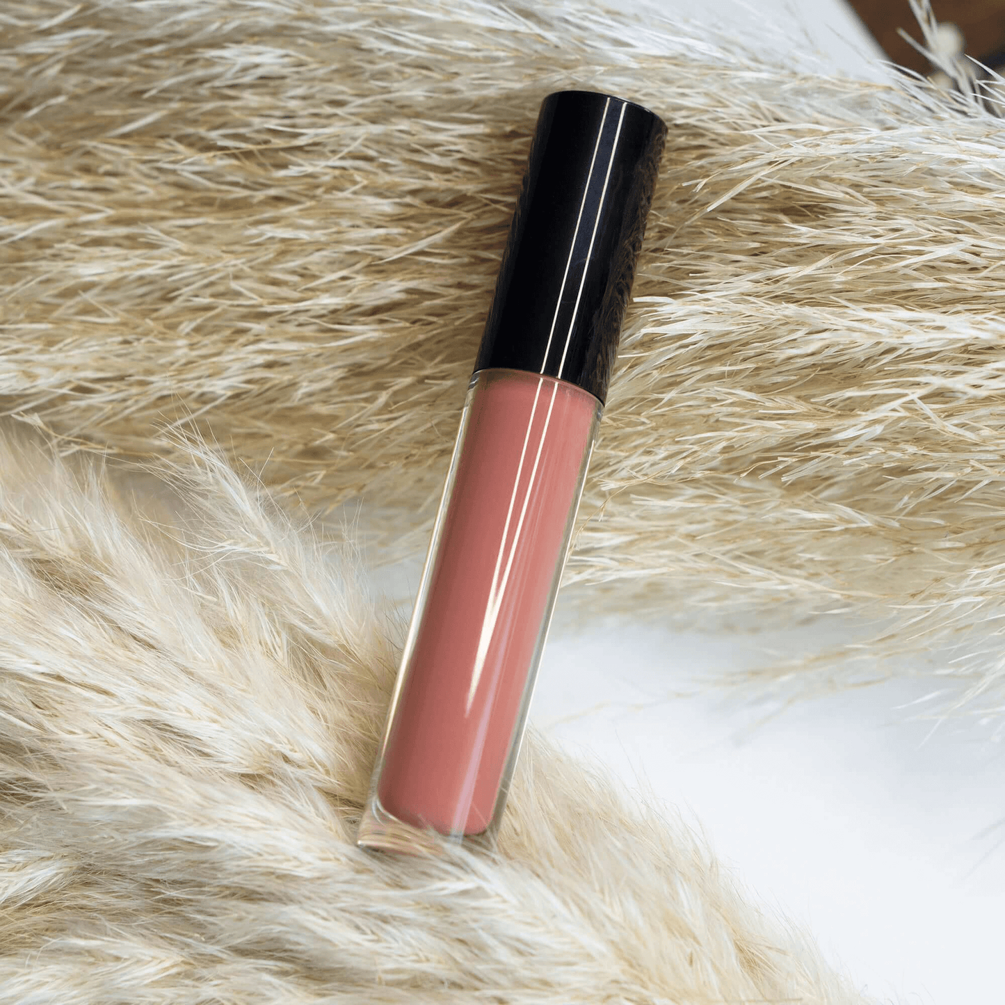 MIANIMED Premium skincare lip gloss on soft natural background