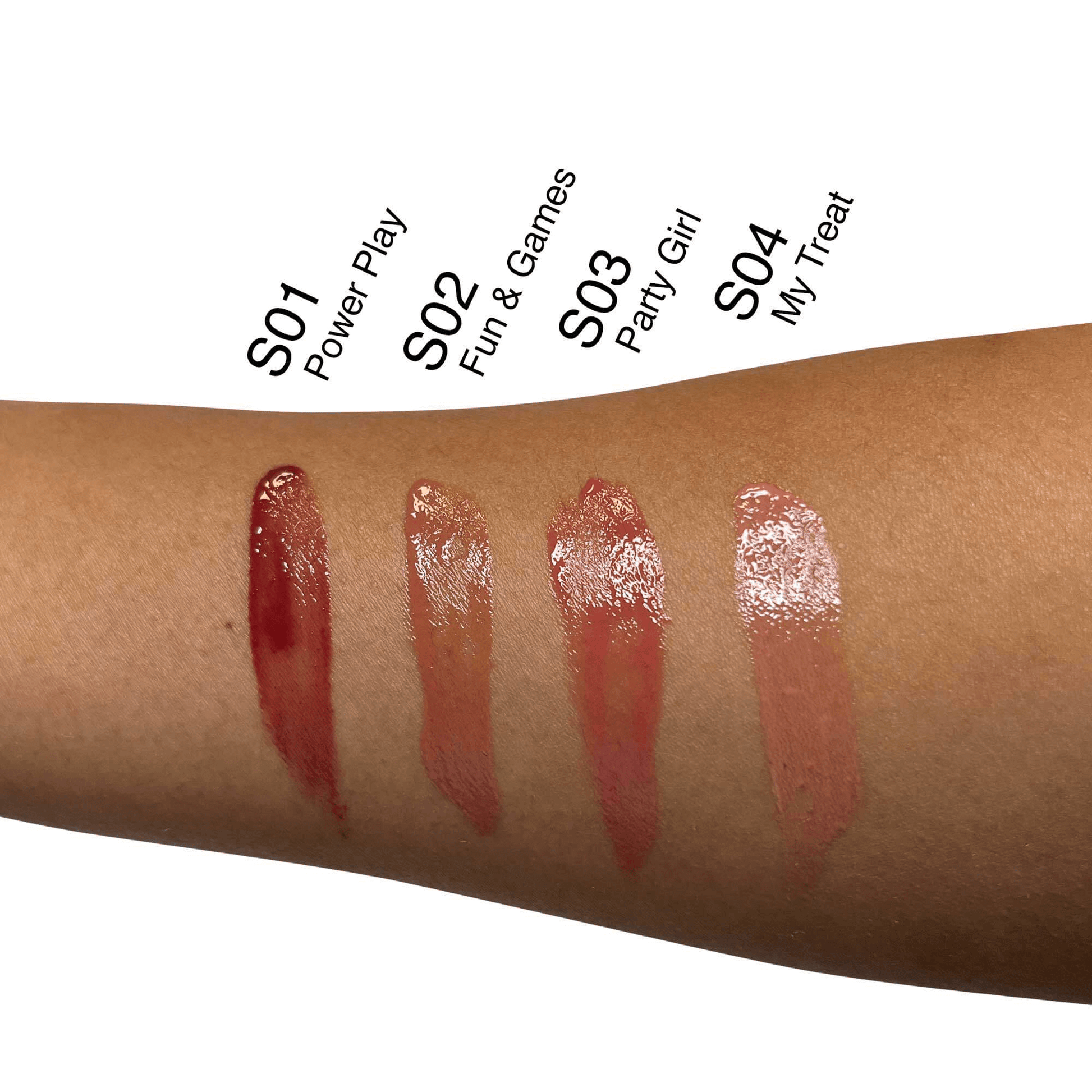 Swatches of MIANIMED premium skincare lip glosses in shades S01 Power Play, S02 Fun & Games, S03 Party Girl, and S04 My Treat on a forearm.