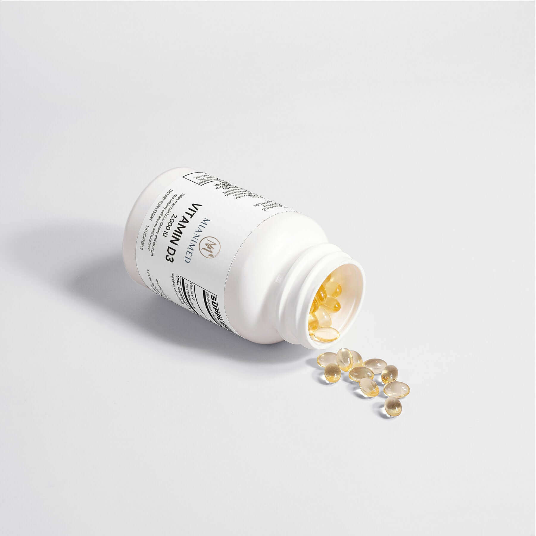 MIANIMED Premium Vitamin D3 supplement bottle on its side with capsules spilling out, representing premium skincare nutrients.